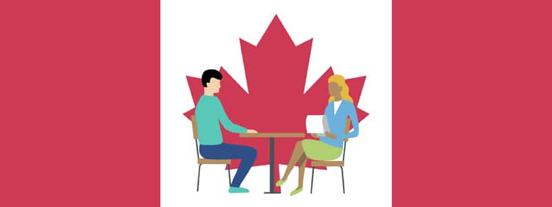 Illustration of a man and a woman sitting at a table, facing each other with a laptop, in front of a large red maple leaf, resembling the Canadian flag.